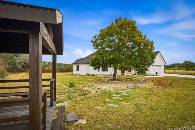 a view of a house with a backyard