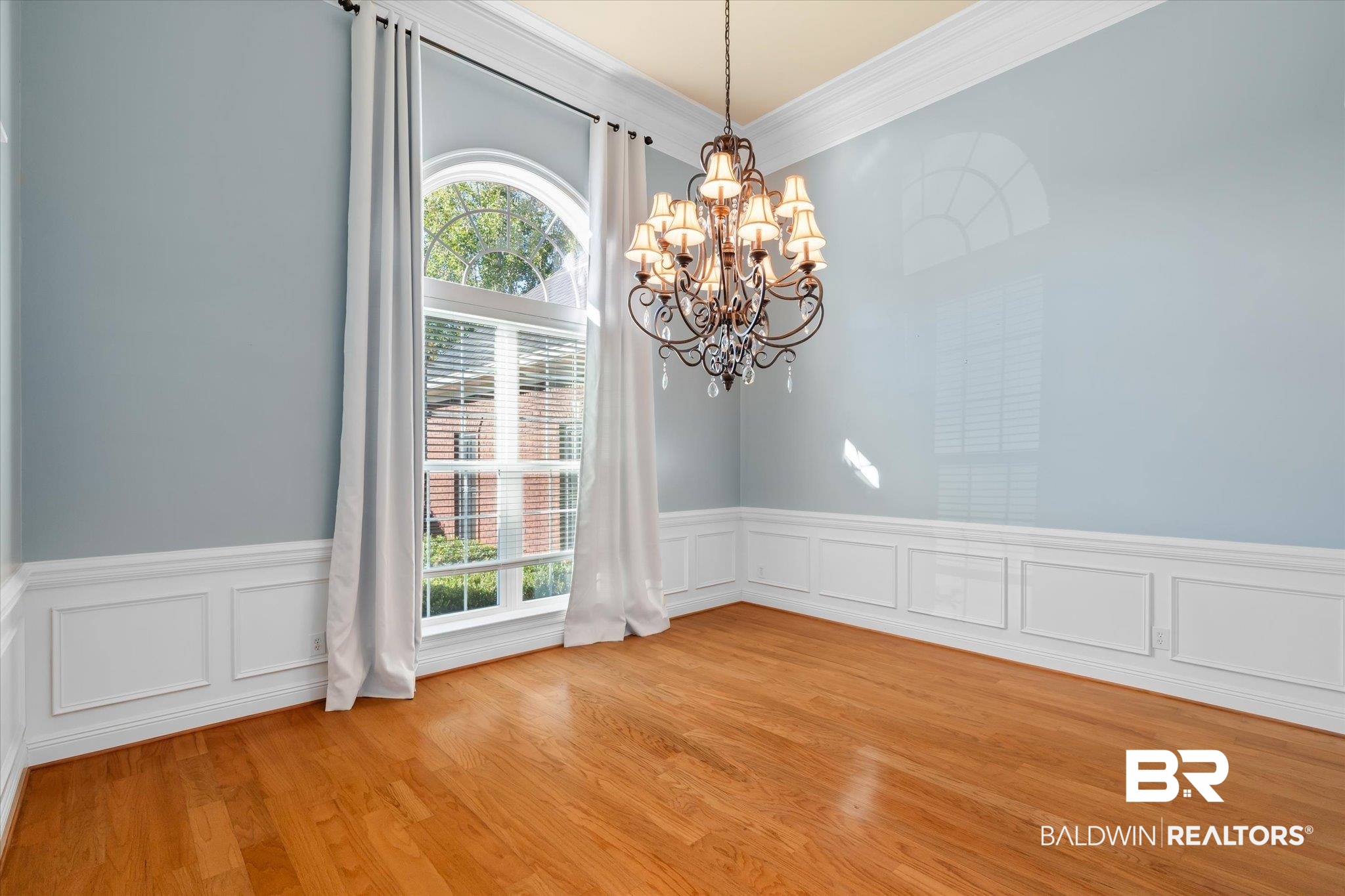 10730 Flagstone Drive Mobile, AL 36608 - Photo 3 of 20 Spare room with crown molding, a notable chandelier, and light hardwood / wood-style floors