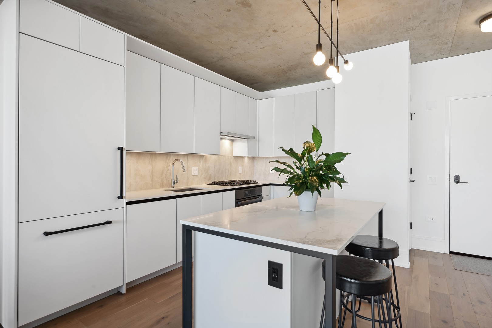 234 West Polk Street, Unit 2610 Chicago, IL 60607 - Photo 11 of 43 a kitchen with stainless steel appliances a sink a refrigerator and a counter top space