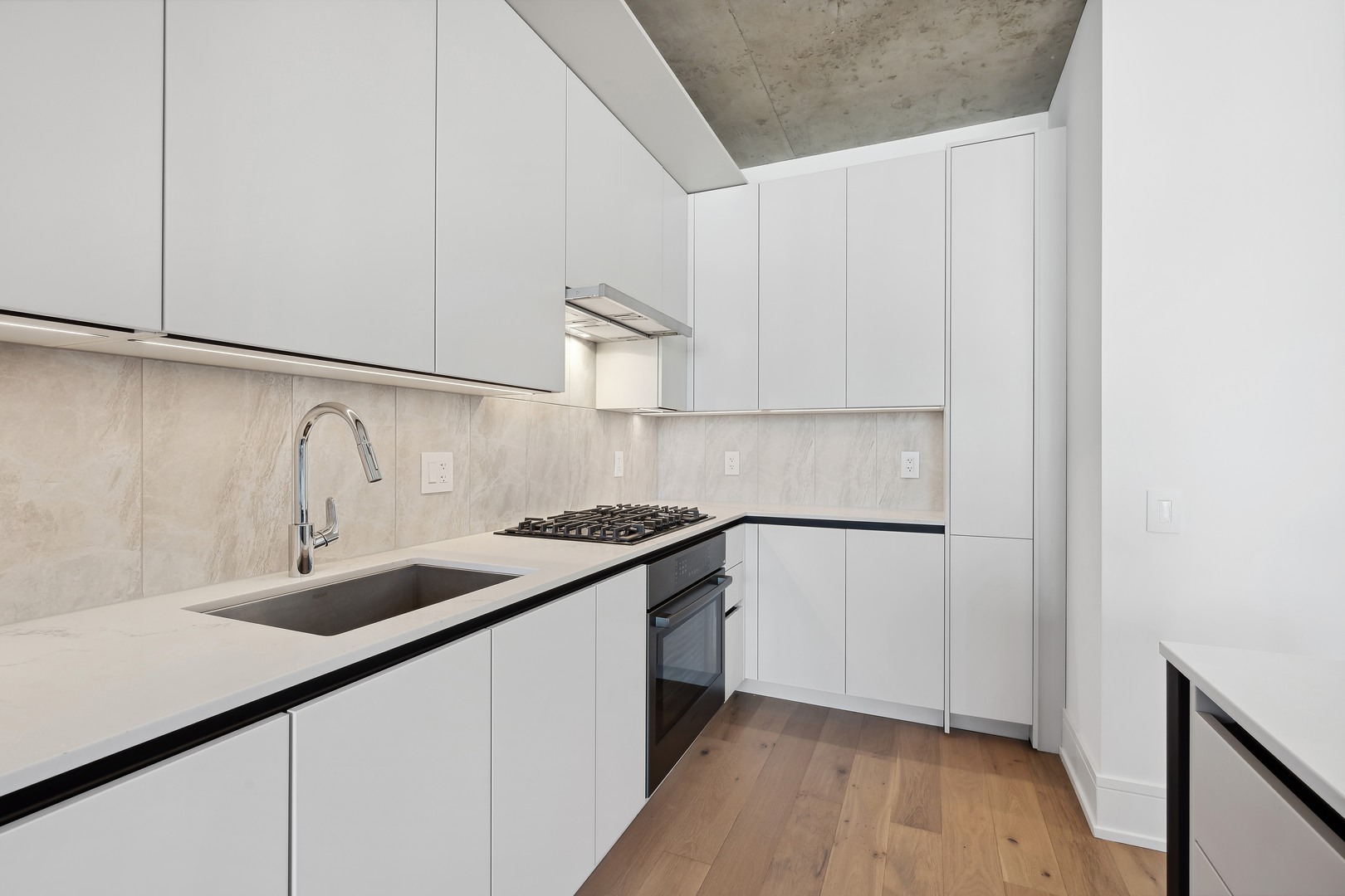 234 West Polk Street, Unit 2610 Chicago, IL 60607 - Photo 13 of 43 a kitchen with granite countertop white cabinets and a sink