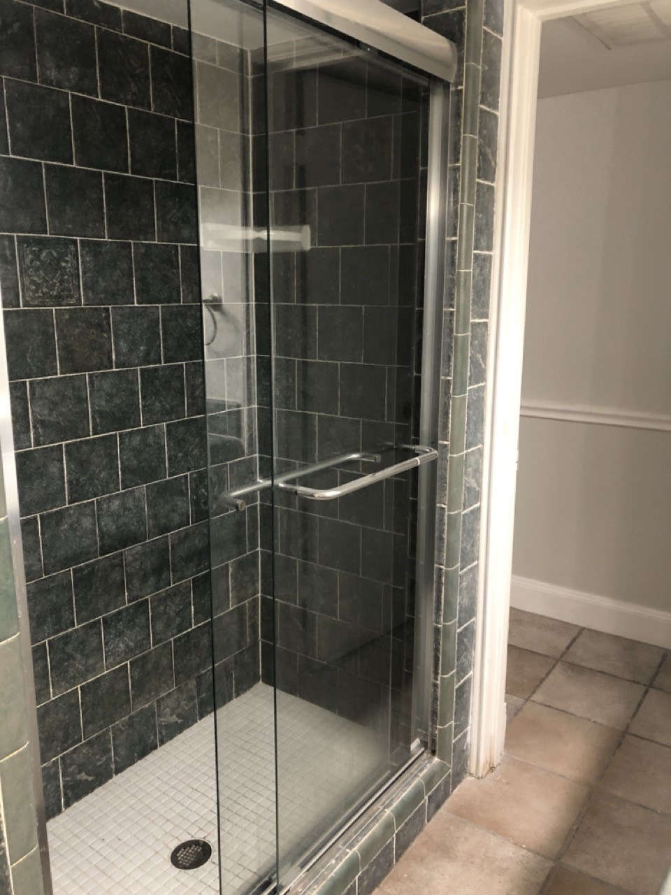 4641 Wild Indigo Street, Unit 439 Houston, TX 77027 - Photo 9 of 10 a bathroom with a glass shower door