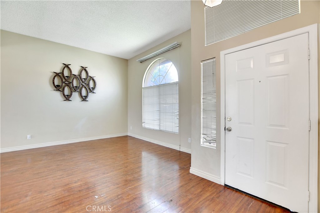 14527 Pony Trail Road Victorville, CA 92392 - Photo 17 of 21 an empty room with wooden floor and windows