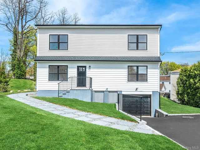 a front view of a house with a yard and garage