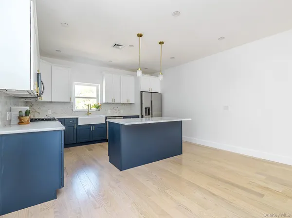 a kitchen with stainless steel appliances kitchen island sink stove and cabinets