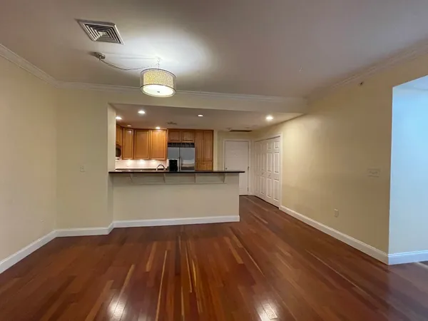 a view of kitchen with sink and wooden floor