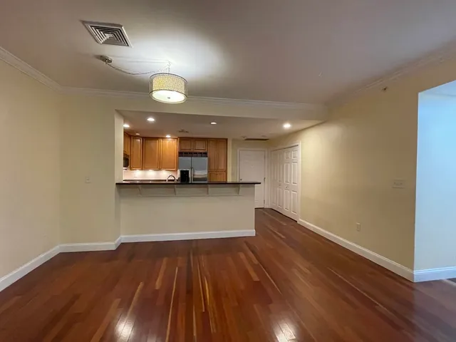 a view of kitchen with sink and wooden floor