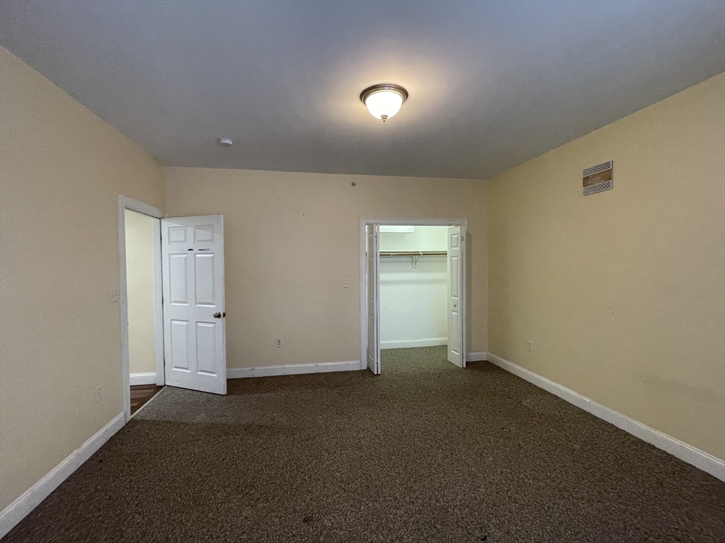 81-87 Fairmount Avenue, Unit 8 Boston, MA 02136 - Photo 5 of 12 an empty room with windows