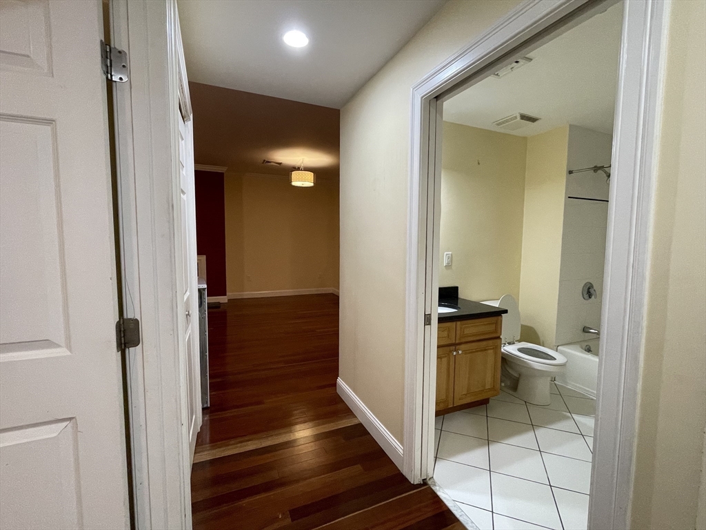 81-87 Fairmount Avenue, Unit 8 Boston, MA 02136 - Photo 9 of 12 a bathroom with a sink a toilet and shower