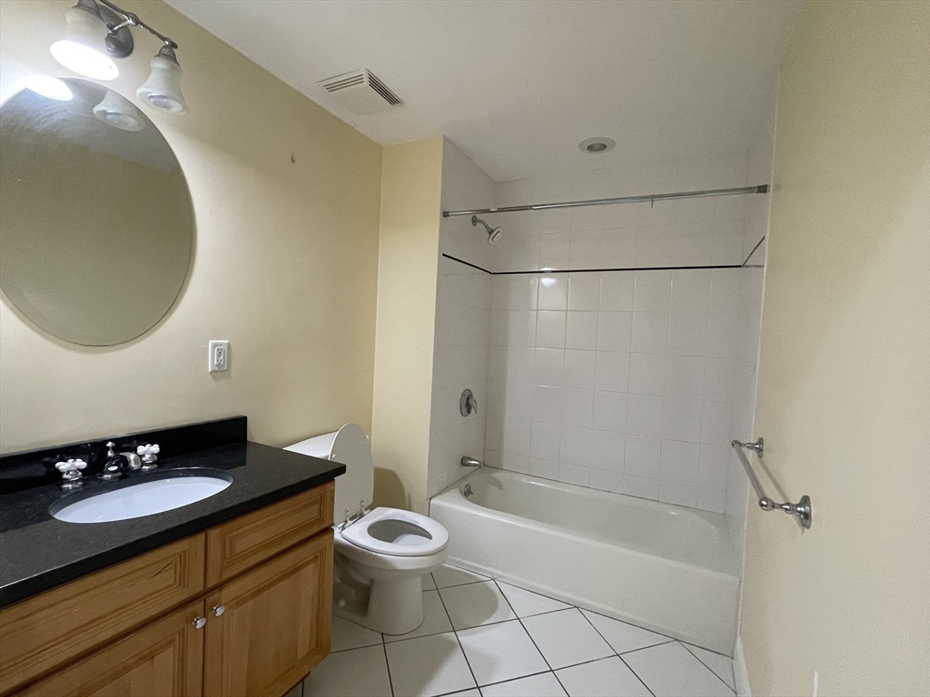 81-87 Fairmount Avenue, Unit 8 Boston, MA 02136 - Photo 10 of 12 a bathroom with a sink a toilet and shower