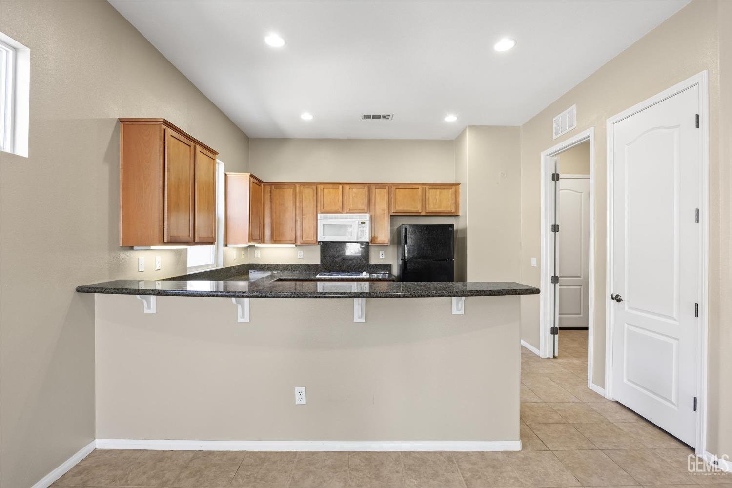 Undisclosed Address Bakersfield, CA 93306 - Photo 14 of 35 a view of kitchen with stainless steel appliances granite countertop a refrigerator and a sink