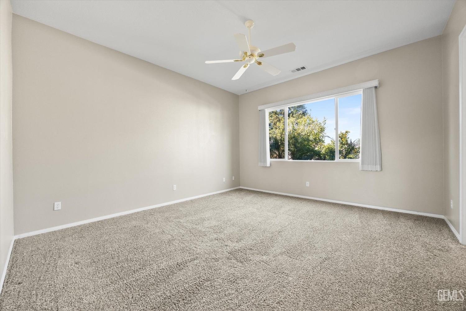 Undisclosed Address Bakersfield, CA 93306 - Photo 18 of 35 an empty room with windows and chandelier fan