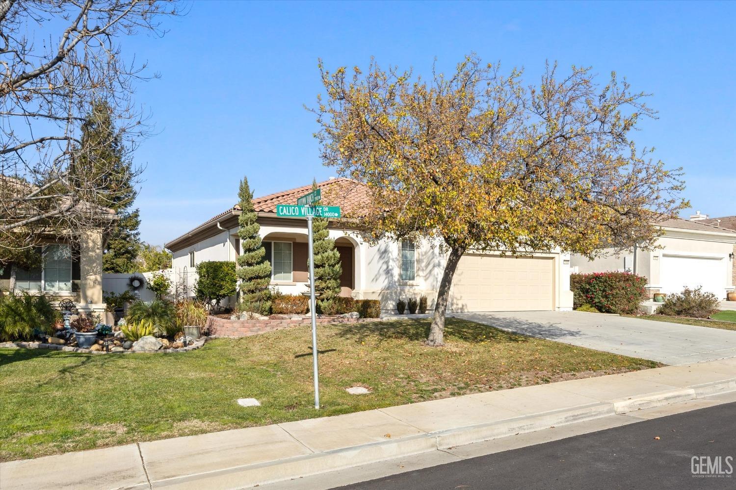Undisclosed Address Bakersfield, CA 93306 - Photo 2 of 35 a front view of a house with garden