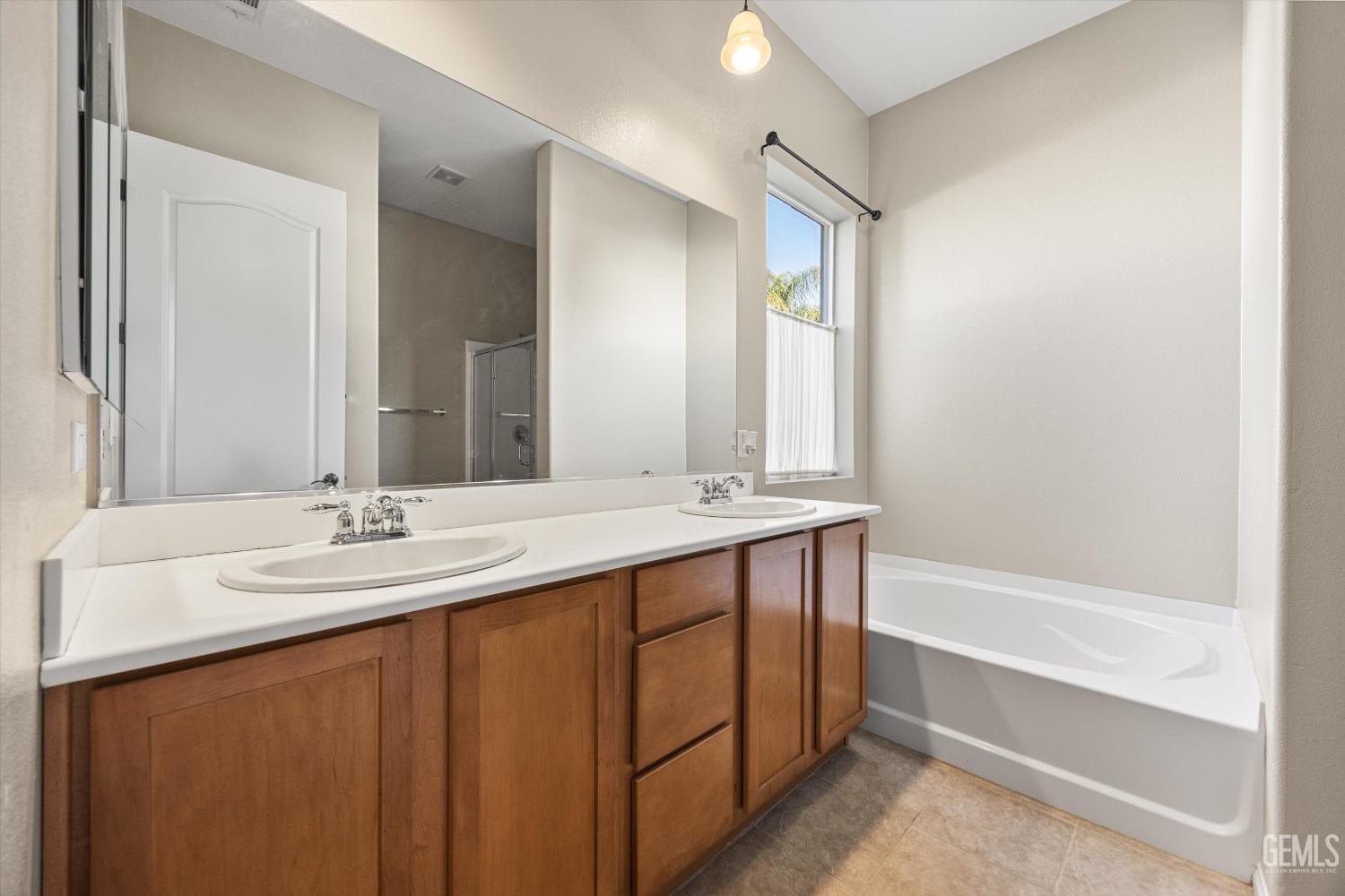 Undisclosed Address Bakersfield, CA 93306 - Photo 21 of 35 a bathroom with a double vanity sink and a mirror