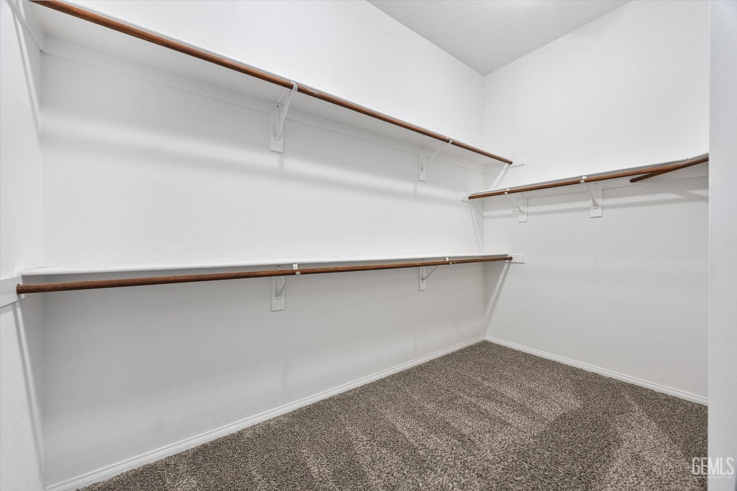 Undisclosed Address Bakersfield, CA 93306 - Photo 22 of 35 a view of an empty walk in closet
