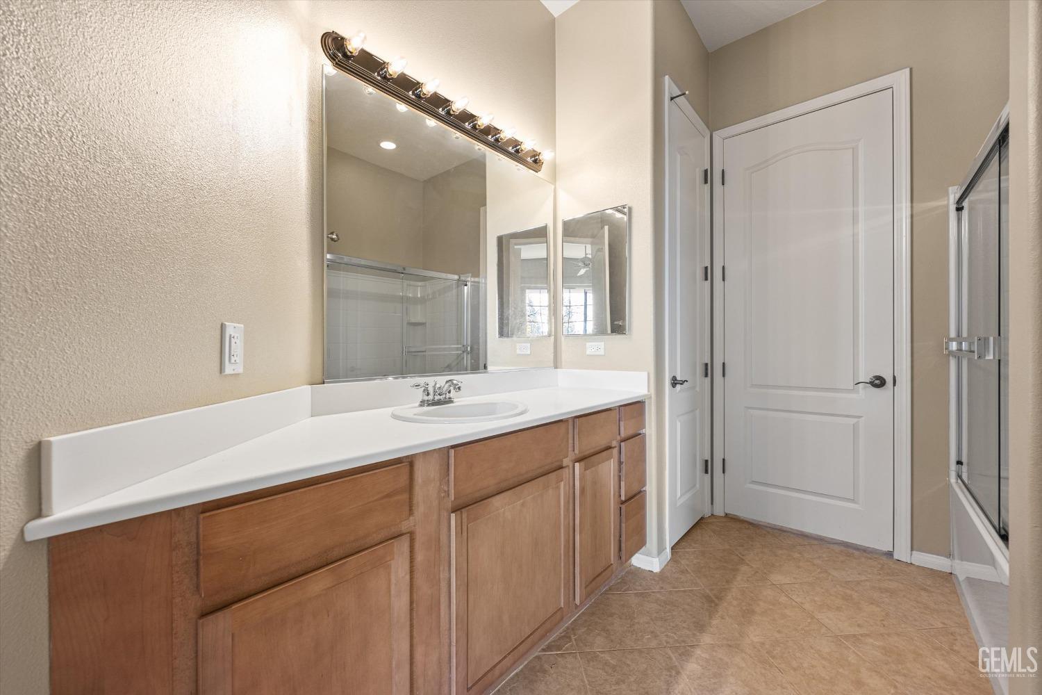 Undisclosed Address Bakersfield, CA 93306 - Photo 24 of 35 a bathroom with a sink and a mirror