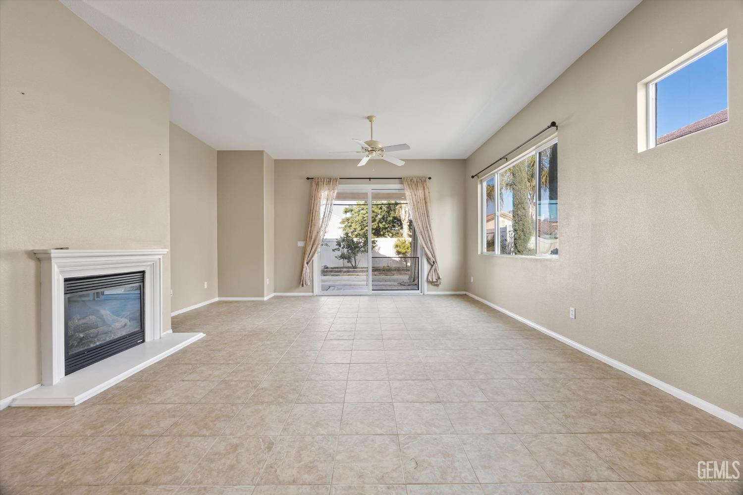 Undisclosed Address Bakersfield, CA 93306 - Photo 8 of 35 an empty room with windows and fireplace