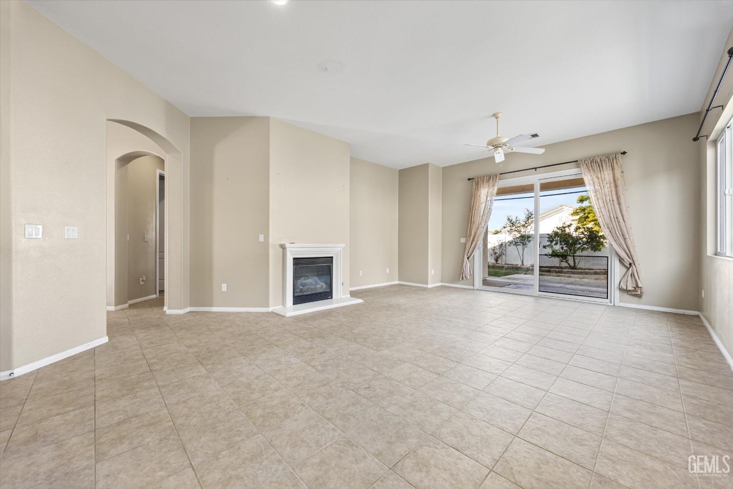Undisclosed Address Bakersfield, CA 93306 - Photo 9 of 35 an empty room with windows and fireplace
