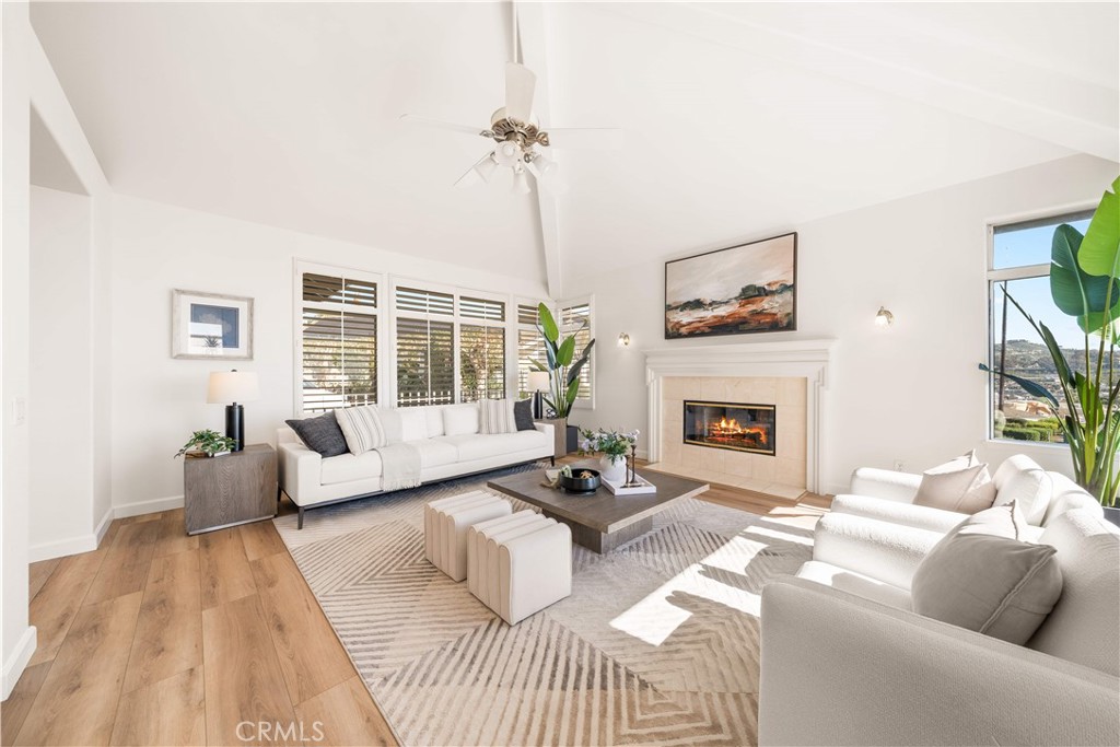 34152 Cambridge Road Dana Point, CA 92629 - Photo 15 of 70 a living room with furniture large window and a fireplace