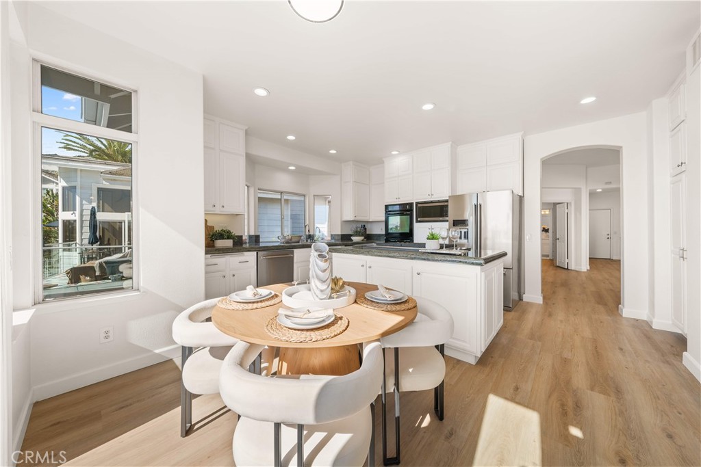 34152 Cambridge Road Dana Point, CA 92629 - Photo 28 of 70 a kitchen with a dining table chairs and refrigerator
