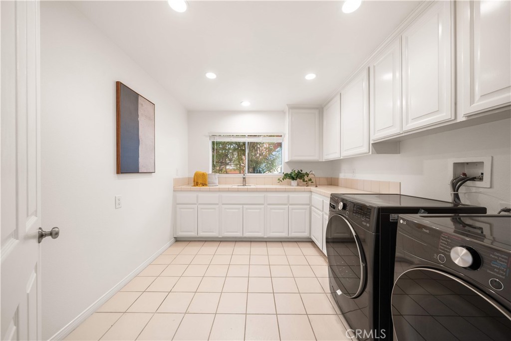 34152 Cambridge Road Dana Point, CA 92629 - Photo 44 of 70 a kitchen with a sink a stove cabinets and counter space
