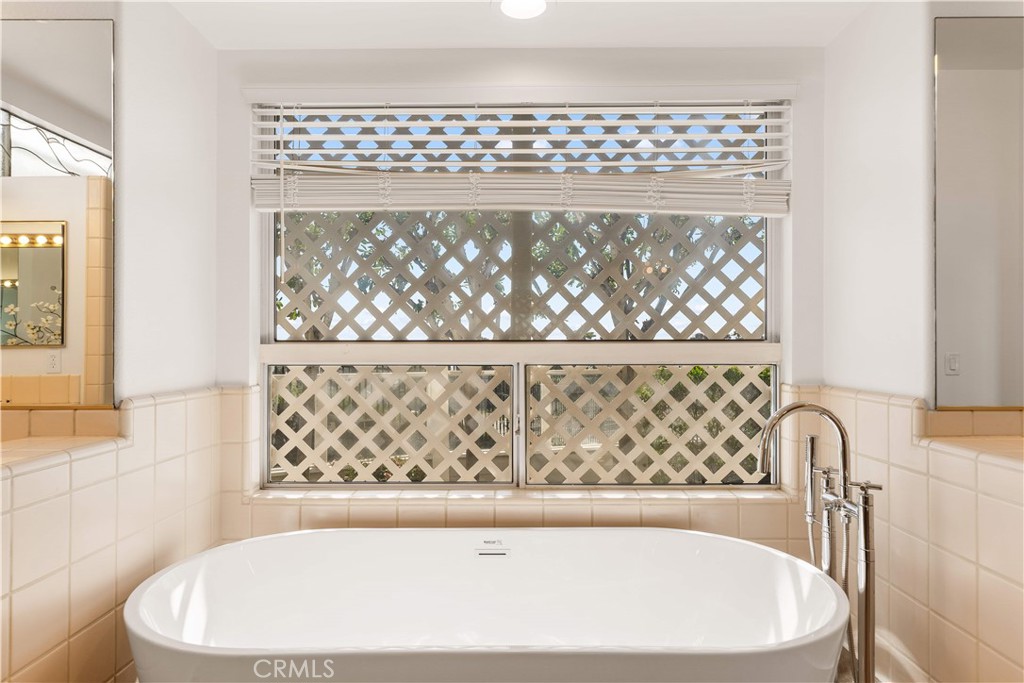 34152 Cambridge Road Dana Point, CA 92629 - Photo 53 of 70 a white bath tub sitting in a bathroom next to a window
