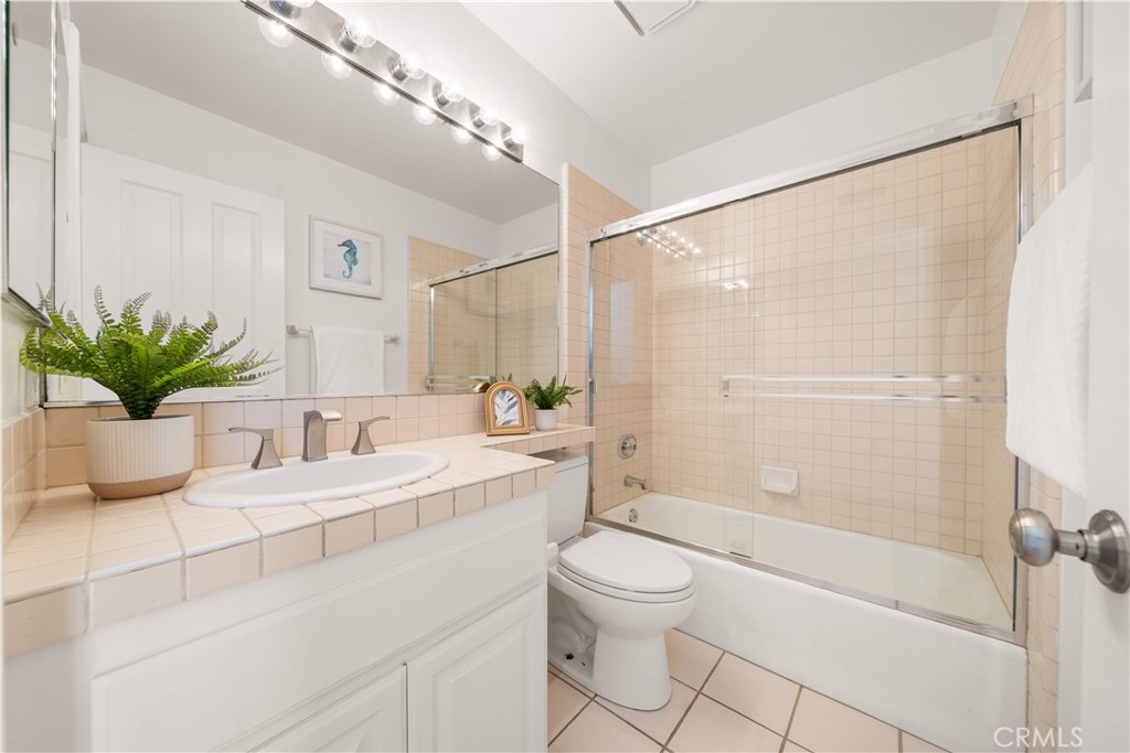 34152 Cambridge Road Dana Point, CA 92629 - Photo 59 of 70 a bathroom with a granite countertop sink a toilet and shower