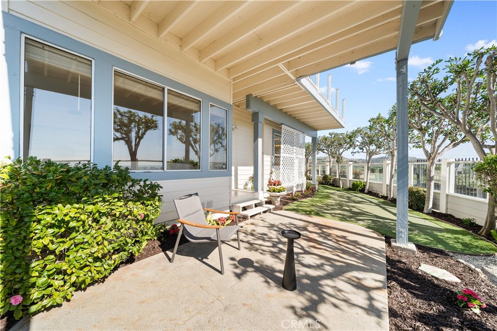 34152 Cambridge Road Dana Point, CA 92629 - Photo 61 of 70 a view of a patio with table and chairs and potted plants