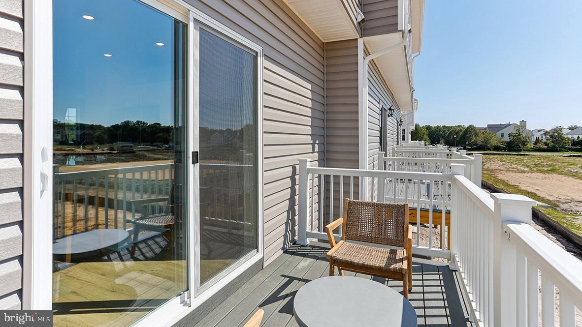 159 Sandy Rdg Road Sicklerville, NJ 08081 - Photo 4 of 36 a view of a balcony with chair and wooden floor