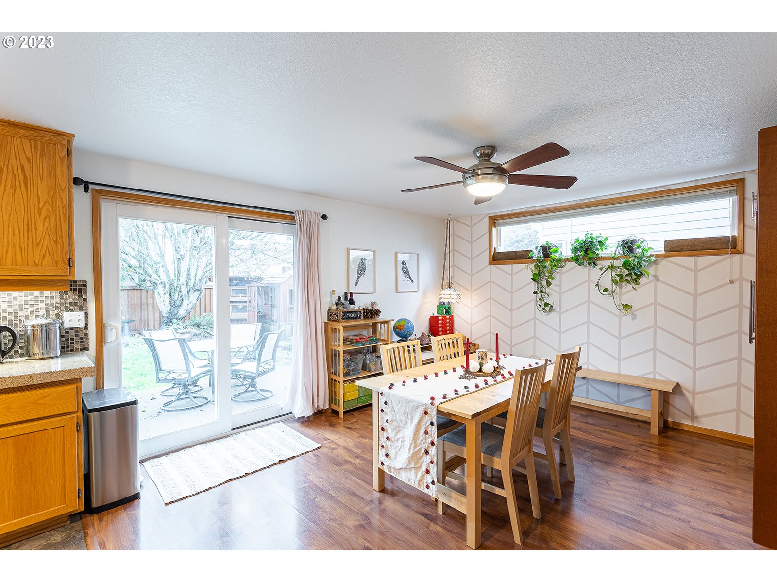 4010 Torrington Avenue Eugene, OR 97404 - Photo 13 of 35 a dining room with furniture a chandelier and wooden floor