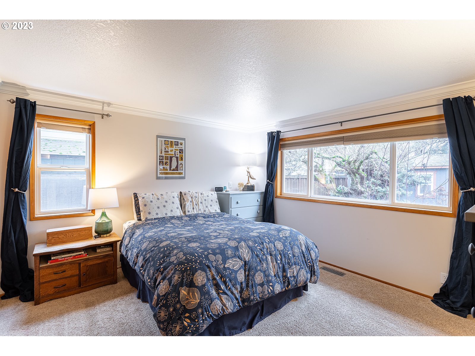 4010 Torrington Avenue Eugene, OR 97404 - Photo 20 of 35 a bedroom with a bed a dresser and a large window