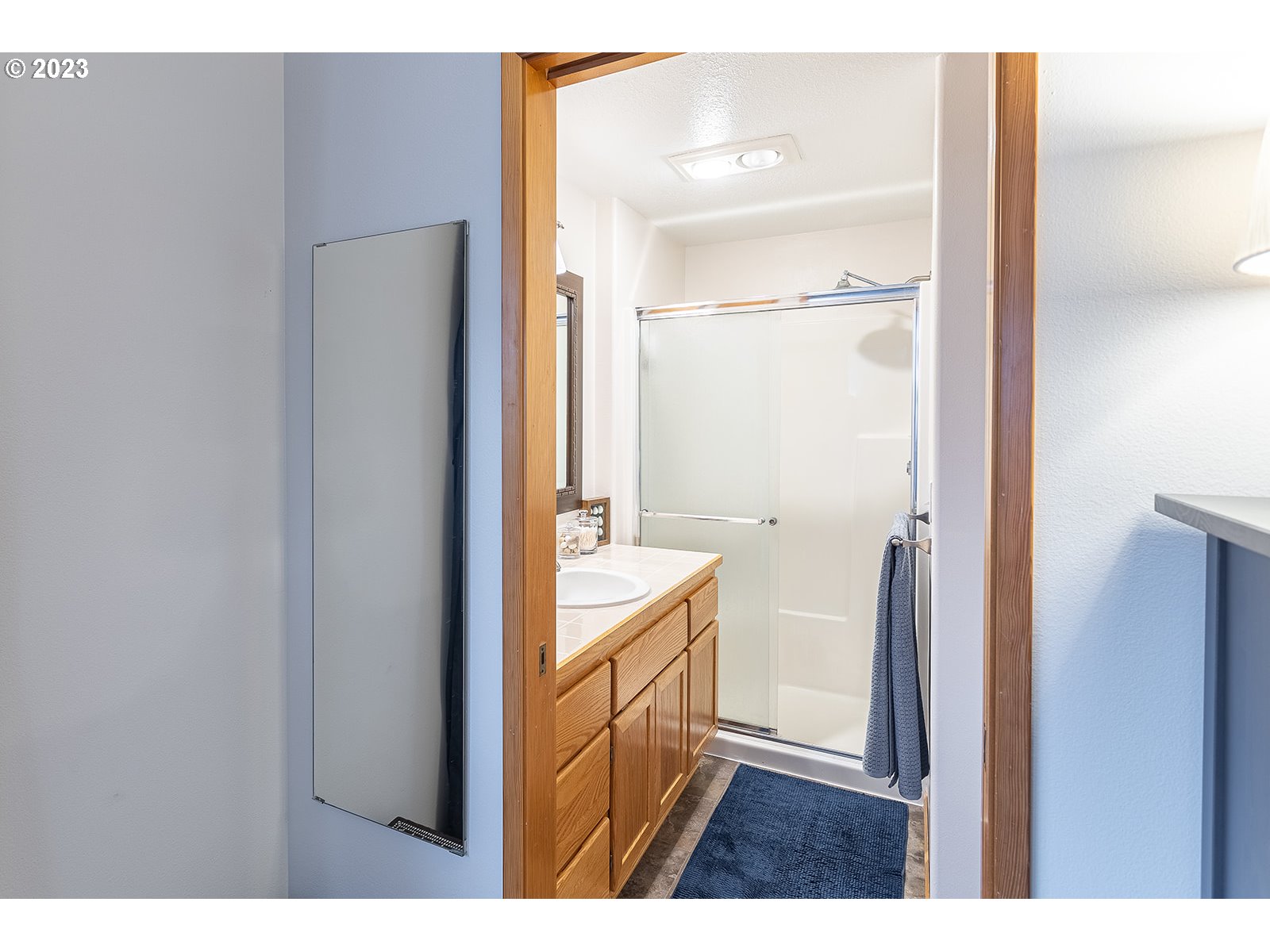 4010 Torrington Avenue Eugene, OR 97404 - Photo 23 of 35 a bathroom with a double vanity sink a mirror and a shower