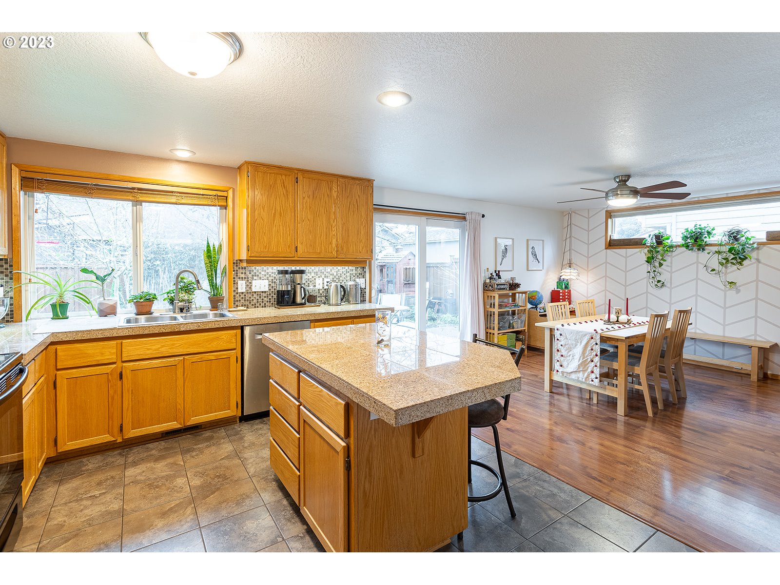 4010 Torrington Avenue Eugene, OR 97404 - Photo 8 of 35 a kitchen with stainless steel appliances granite countertop table chairs and a refrigerator