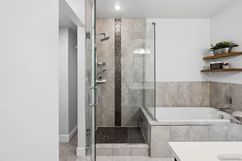 a bathroom with a tub and shower