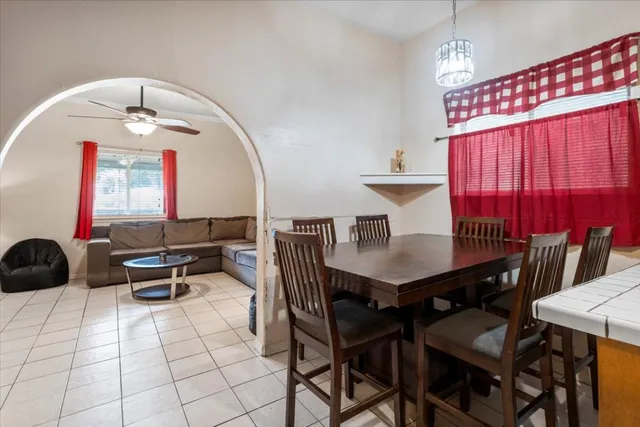 a view of a dining room with furniture and a chandelier