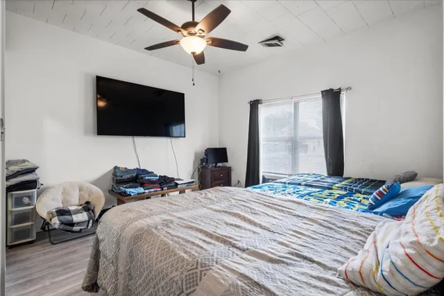 a bedroom with a bed and a flat screen tv