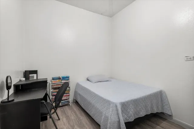 a bedroom with a bed and a desk