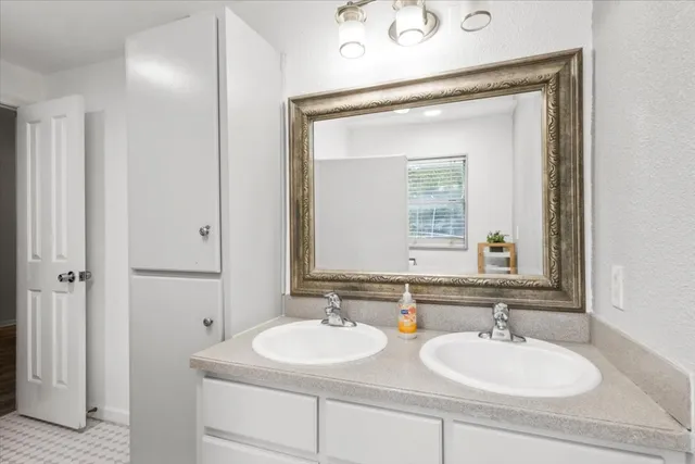 a bathroom with 2 sink and a mirror