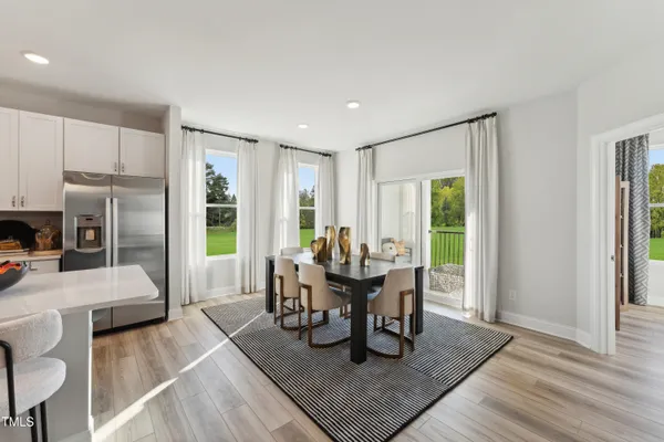 a dining room with furniture and wooden floor