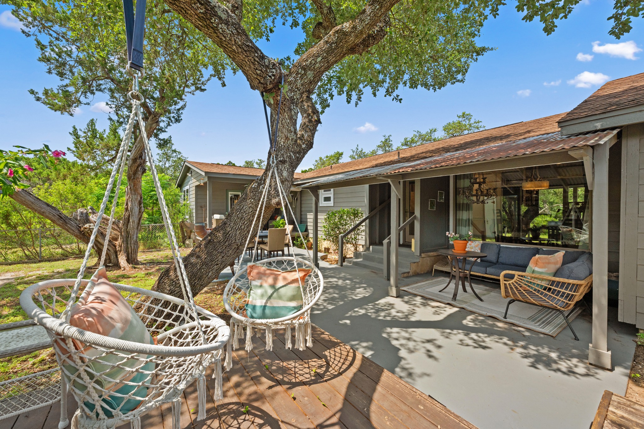 12932 Nutty Brown Road Austin, TX 78737 - Photo 36 of 40 The Ranch - Covered outdoor living area ideal for entertaining or relaxing beneath mature oak trees.