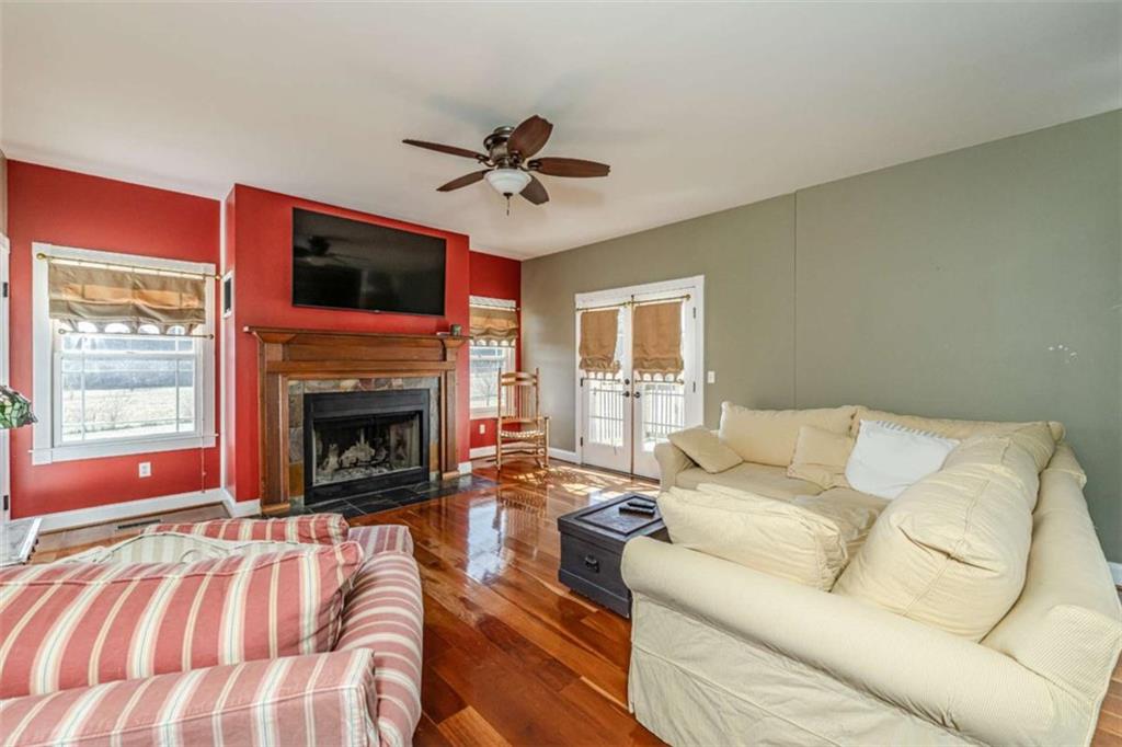6729 Big Texas Valley Road Northwest Rome, GA 30165 - Photo 11 of 32 a living room with furniture a fireplace and a flat screen tv