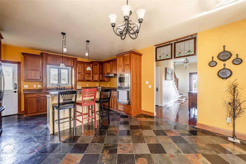 6729 Big Texas Valley Road Northwest Rome, GA 30165 - Photo 13 of 32 a large kitchen with stainless steel appliances granite countertop a refrigerator and a stove top oven