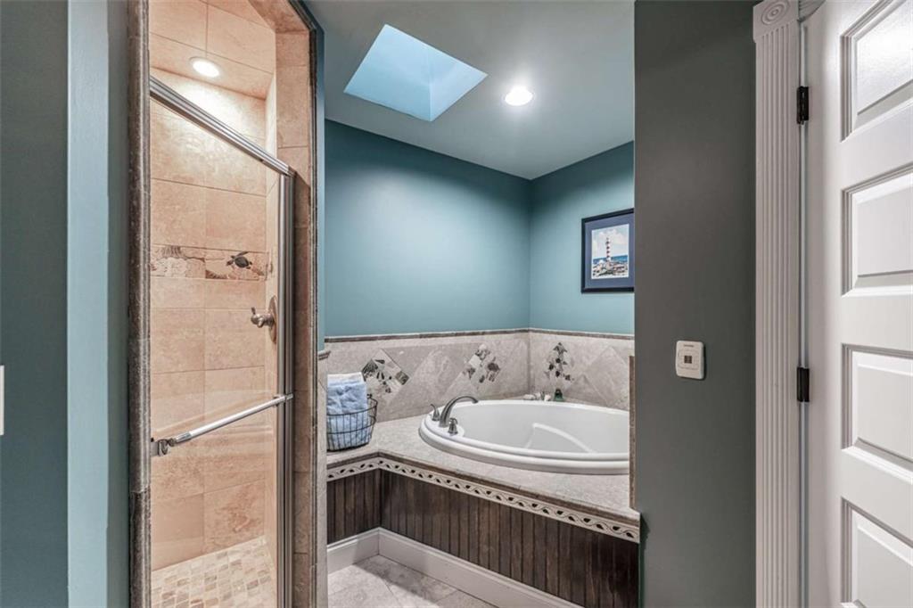 6729 Big Texas Valley Road Northwest Rome, GA 30165 - Photo 26 of 32 a bathroom with a bathtub and shower