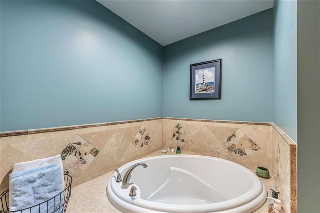 6729 Big Texas Valley Road Northwest Rome, GA 30165 - Photo 28 of 32 a bathroom with a bathtub and a window