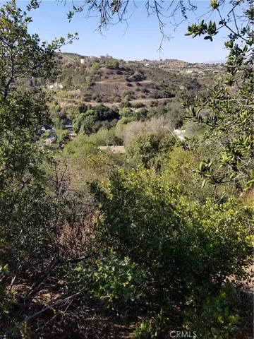 an aerial view of house with yard and mountain view in back