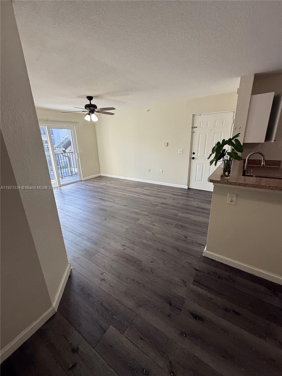 a view of a room with wooden floor