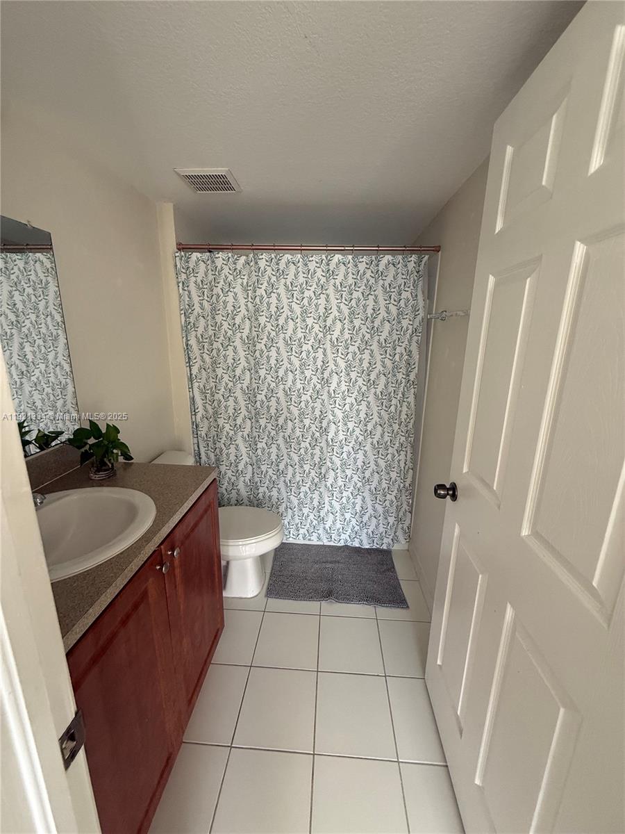 15422 Southwest 284th Street, Unit 7202 Homestead, FL 33033 - Photo 11 of 13 a bathroom with a sink a toilet and shower