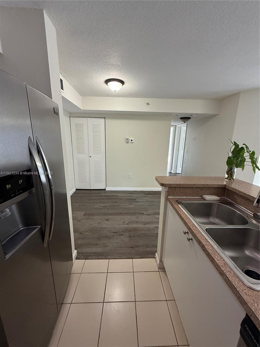 15422 Southwest 284th Street, Unit 7202 Homestead, FL 33033 - Photo 4 of 13 a kitchen with a sink a refrigerator and window