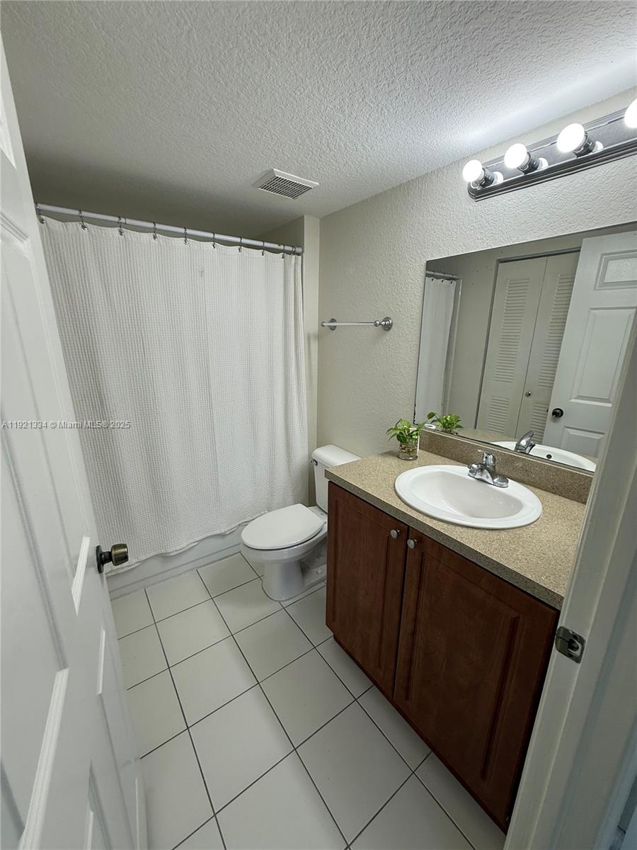 15422 Southwest 284th Street, Unit 7202 Homestead, FL 33033 - Photo 7 of 13 a bathroom with a double vanity sink and mirror