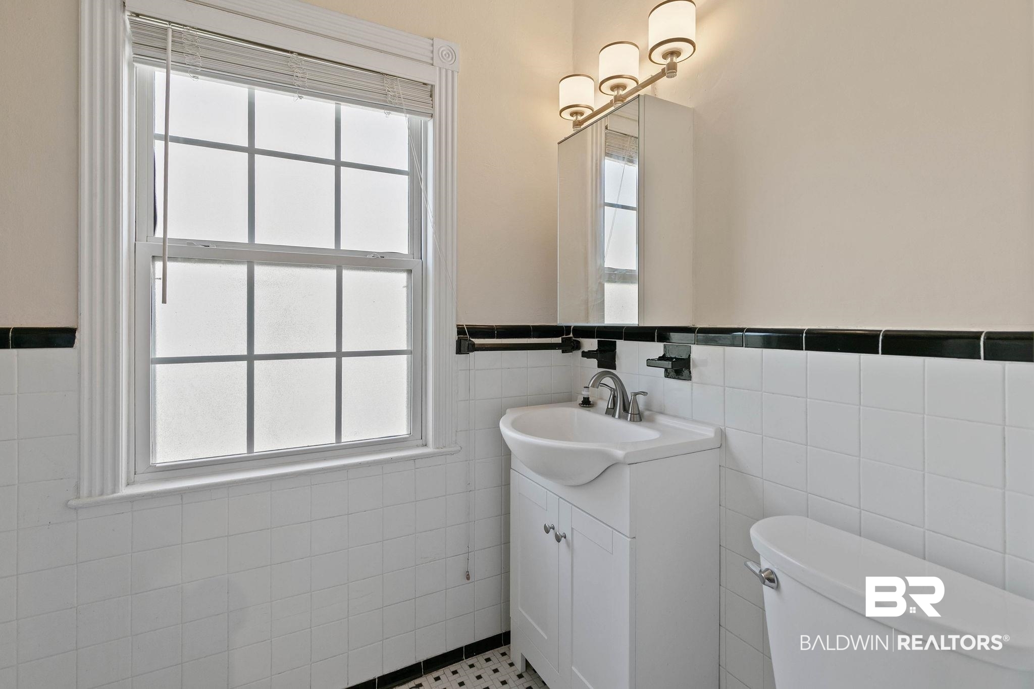 214 Upham Street, Unit 8D Mobile, AL 36607 - Photo 25 of 36 Bathroom with vanity, tile walls, and wainscoting