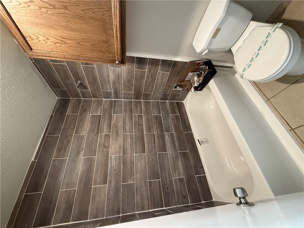 2000 Kazmeier, Unit 11 Bryan, TX 77802 - Photo 10 of 11 a bathroom with a sink a toilet and shower